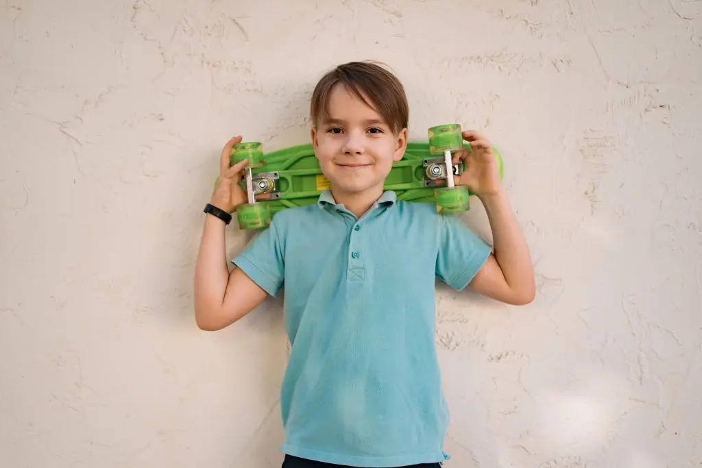 portrait-young-cool-smiling-boy-in-blue-polo-posing-with-penny-board-in-the-hands.jpg